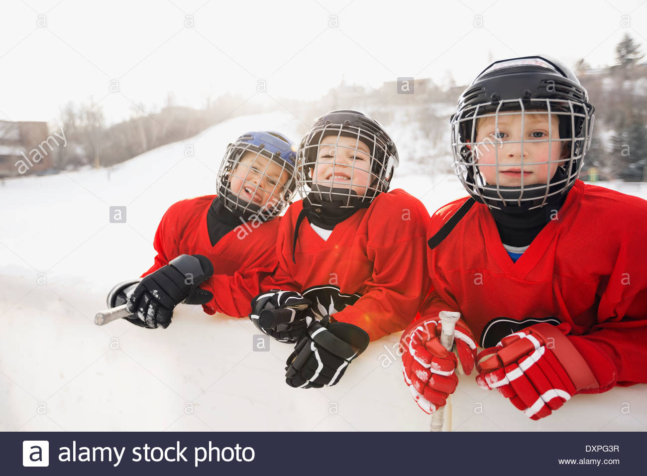 Portrait of ice hockey players leaning on rink wall Stock Photo Alamy