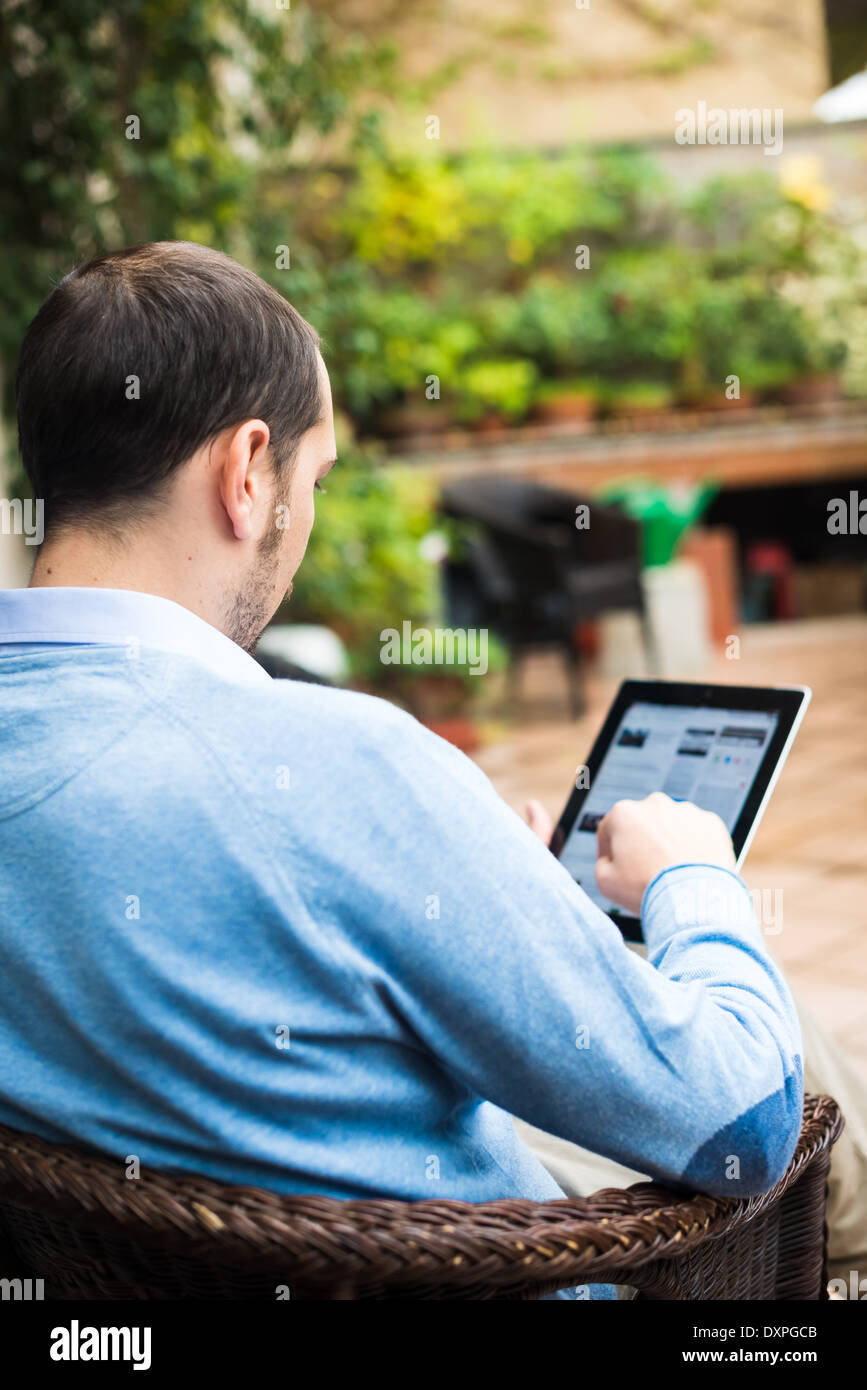 elegant business multitasking multimedia man using devices at home