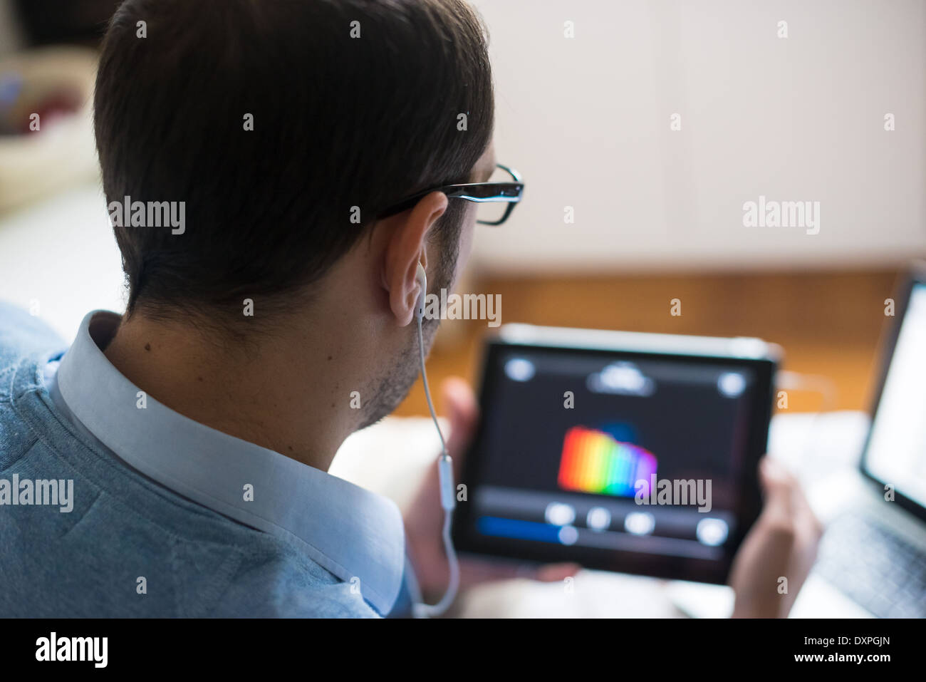 Man Using Devices elegant business multitasking multimedia man using devices at home ...