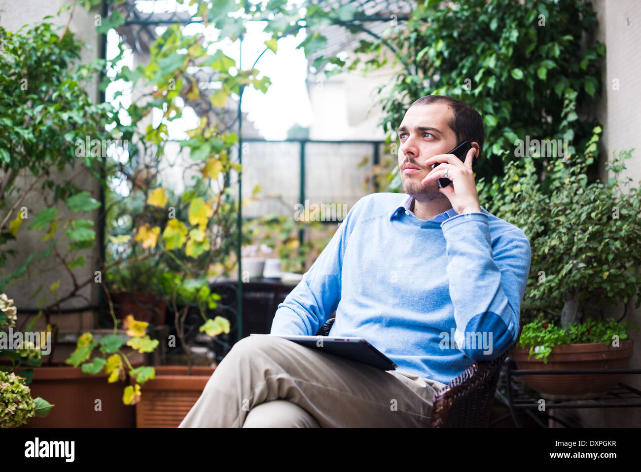 elegant business multitasking multimedia man using devices at home Stock Photo