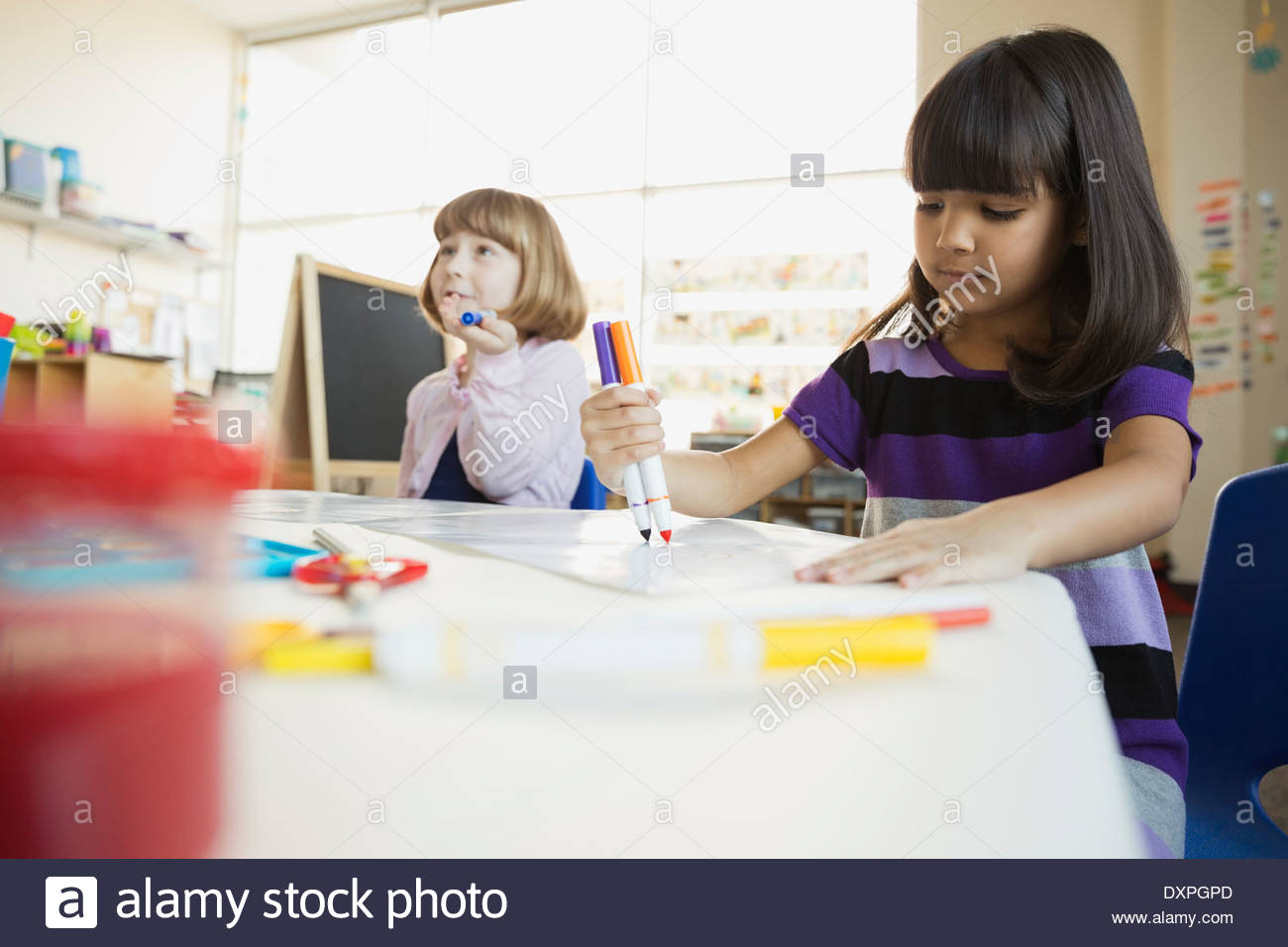 Girls drawing with felt tip pens in art class Stock Photo