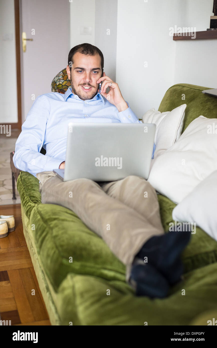 elegant business multitasking multimedia man using devices at home Stock Photo