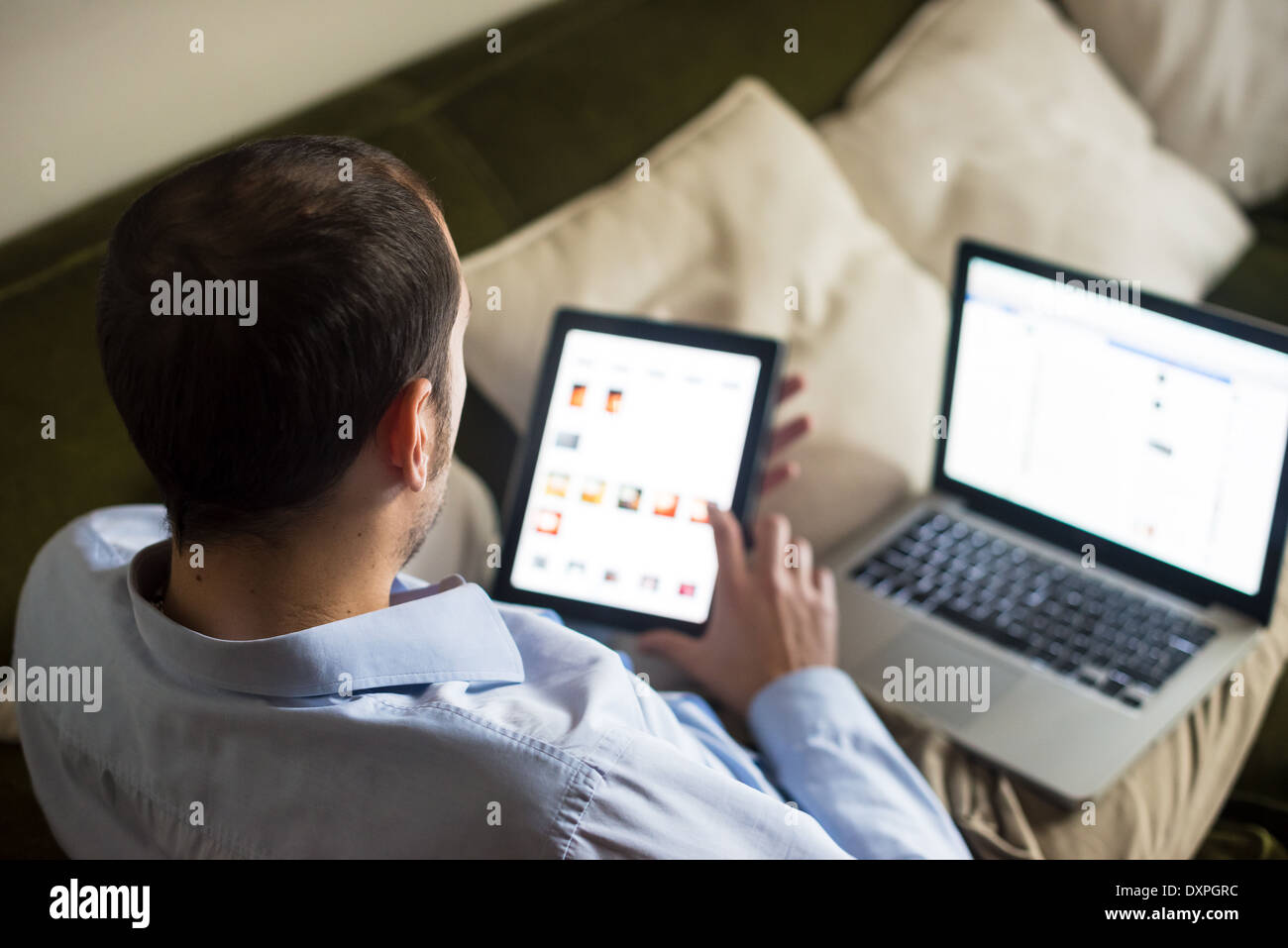 elegant business multitasking multimedia man using devices at home Stock Photo