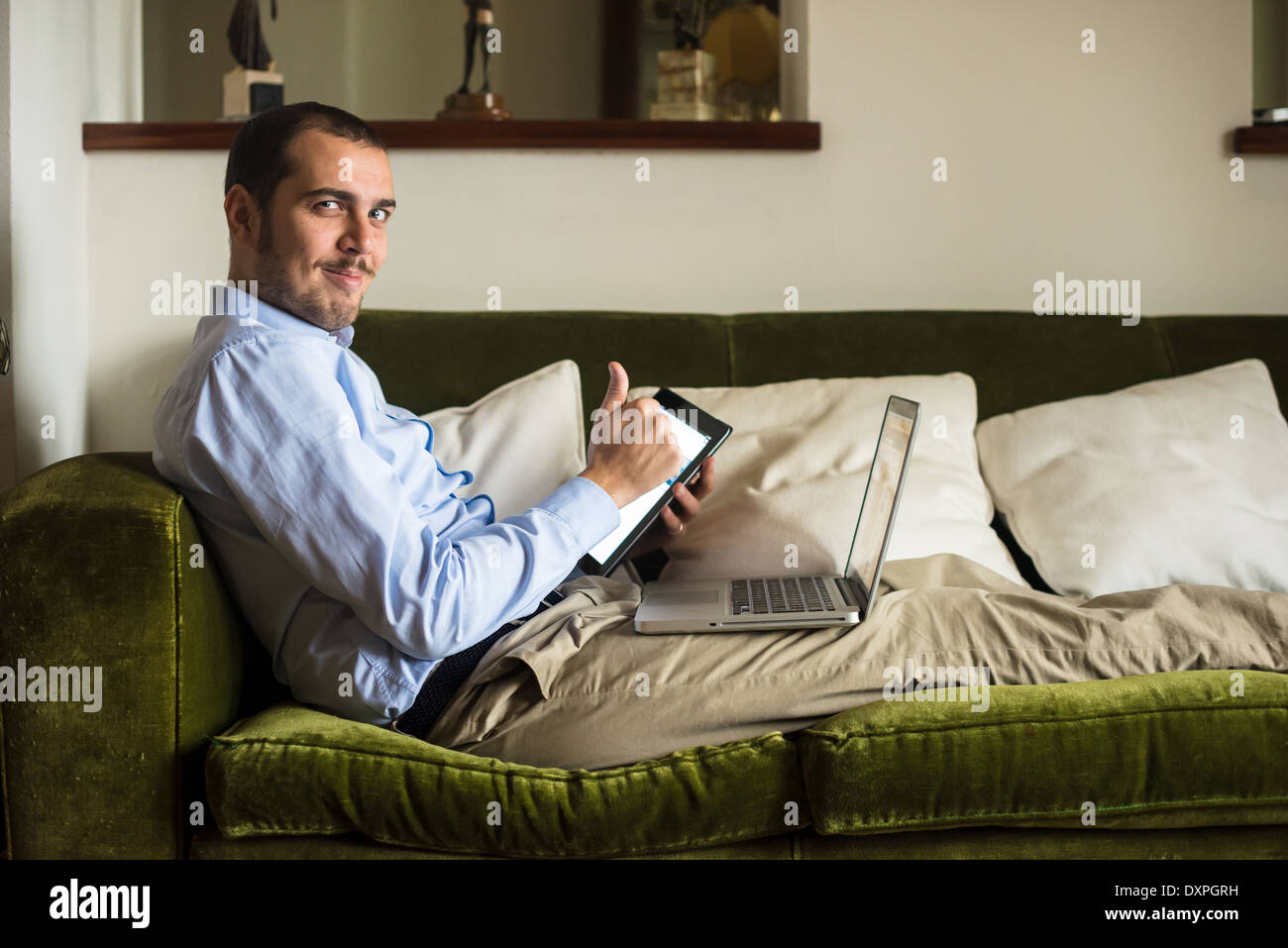 elegant business multitasking multimedia man using devices at home Stock Photo