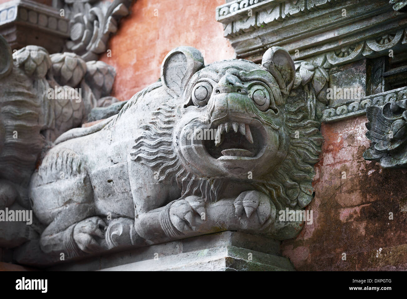Mythical beast like a dog on the wall of temple. Bali, Indonesia Stock Photo