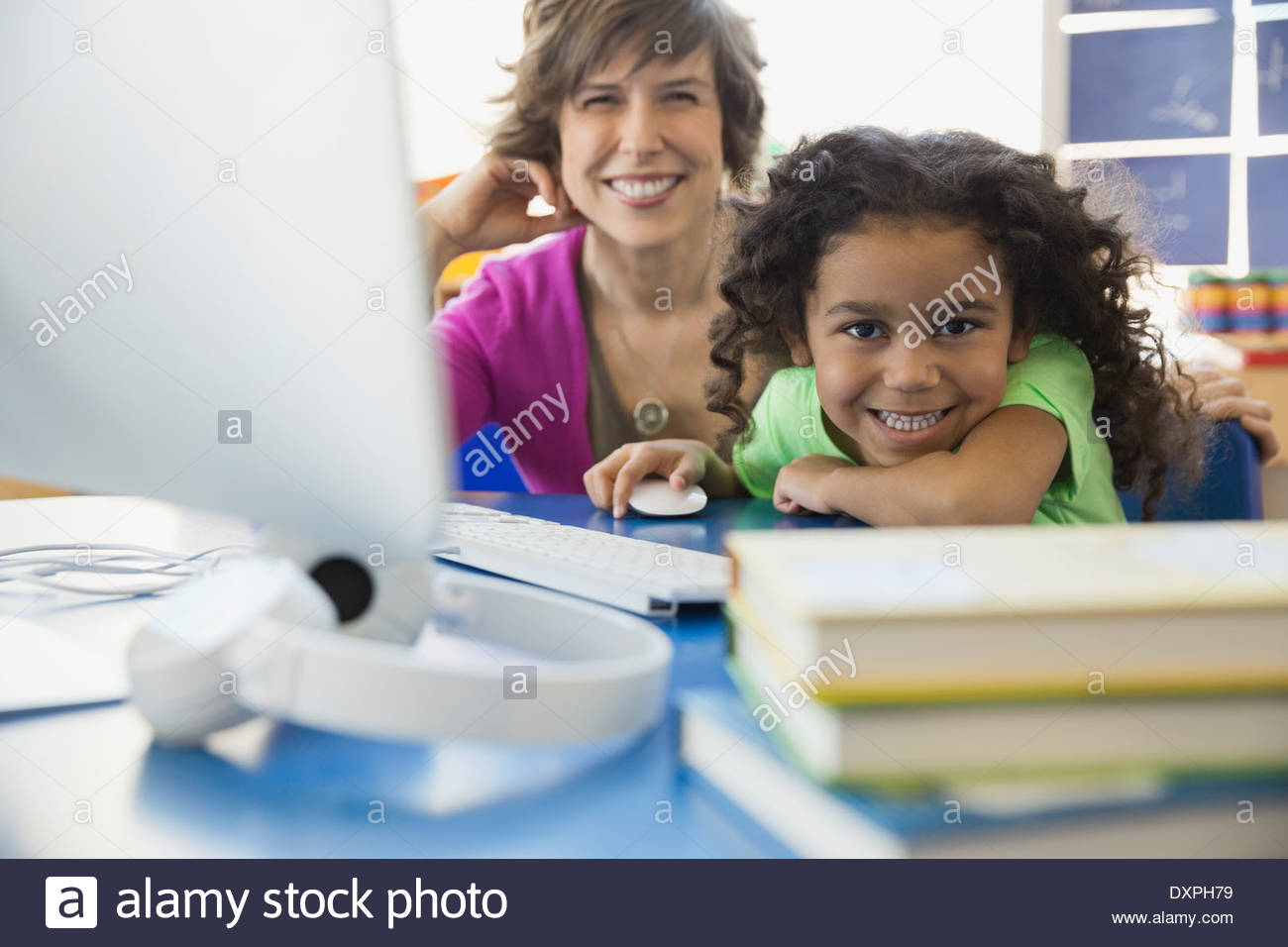 Schoolgirl sitting desk school smiling hi-res stock photography and ...