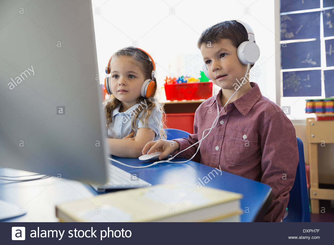Students wearing headphones using computer in school Stock Photo Alamy