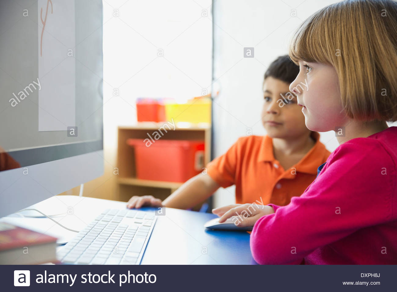 Students using computer in elementary school Stock Photo Alamy