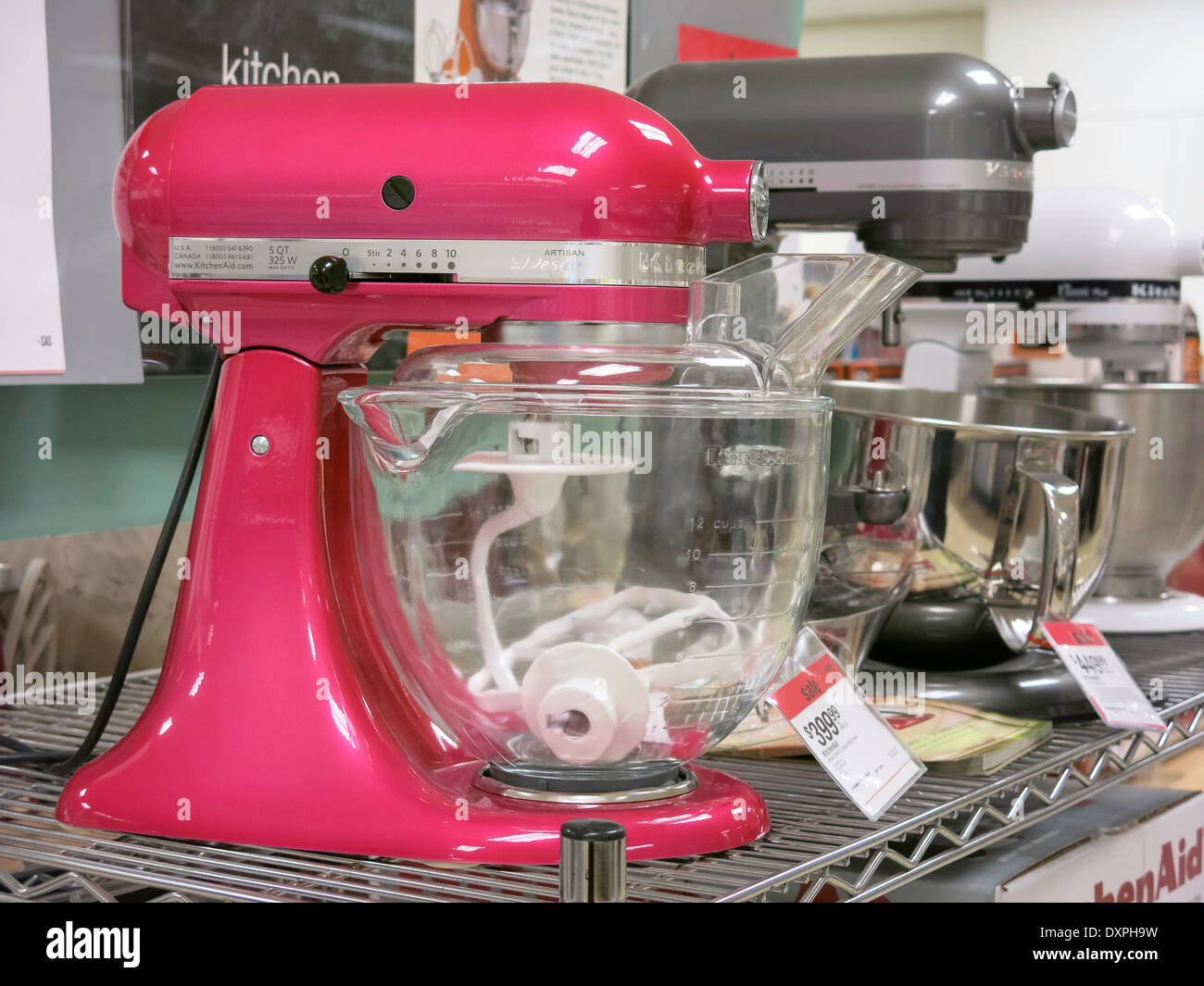 Close-up of red Kitchenaid blender and white Kitchenaid mixer on wooden  worktop below glass-ware on shelves in small kitchen Stock Photo - Alamy