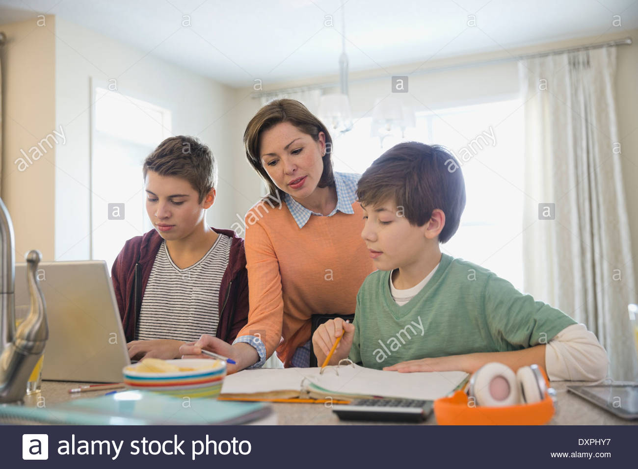 Mother assisting son with homework Stock Photo