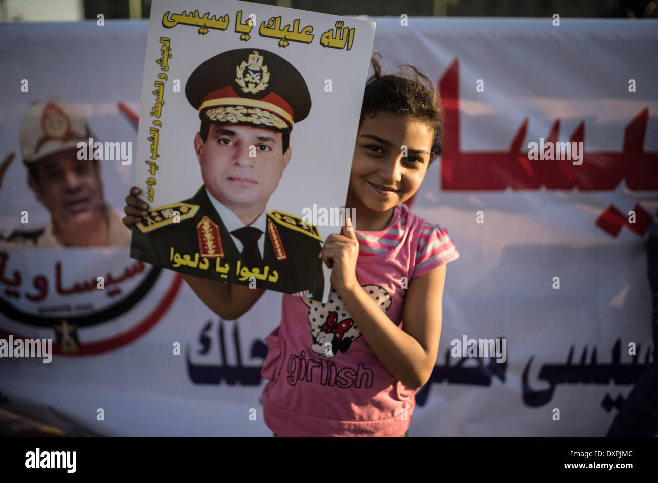 Cairo, Egypt. 28th Mar, 2014. An Egyptian girl holds a poster of Egypt's ex-military chief Abdel-Fattah al-Sisi near Tahrir Square, Cairo, capital of Egypt, March 28, 2014. Over one hundred Sisi's supporters held a demonstration on Friday near the iconic square in the capital for the recently announced presidential bid of ex-military chief. Credit:  Pan Chaoyue/Xinhua/Alamy Live News Stock Photo