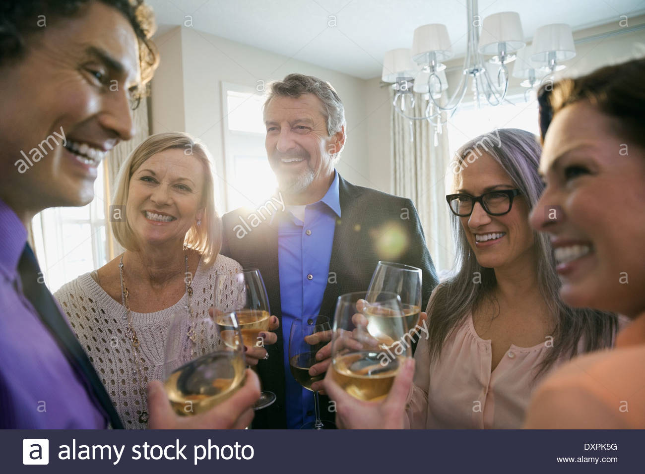 Cheerful family and friends enjoying drinks at party Stock Photo