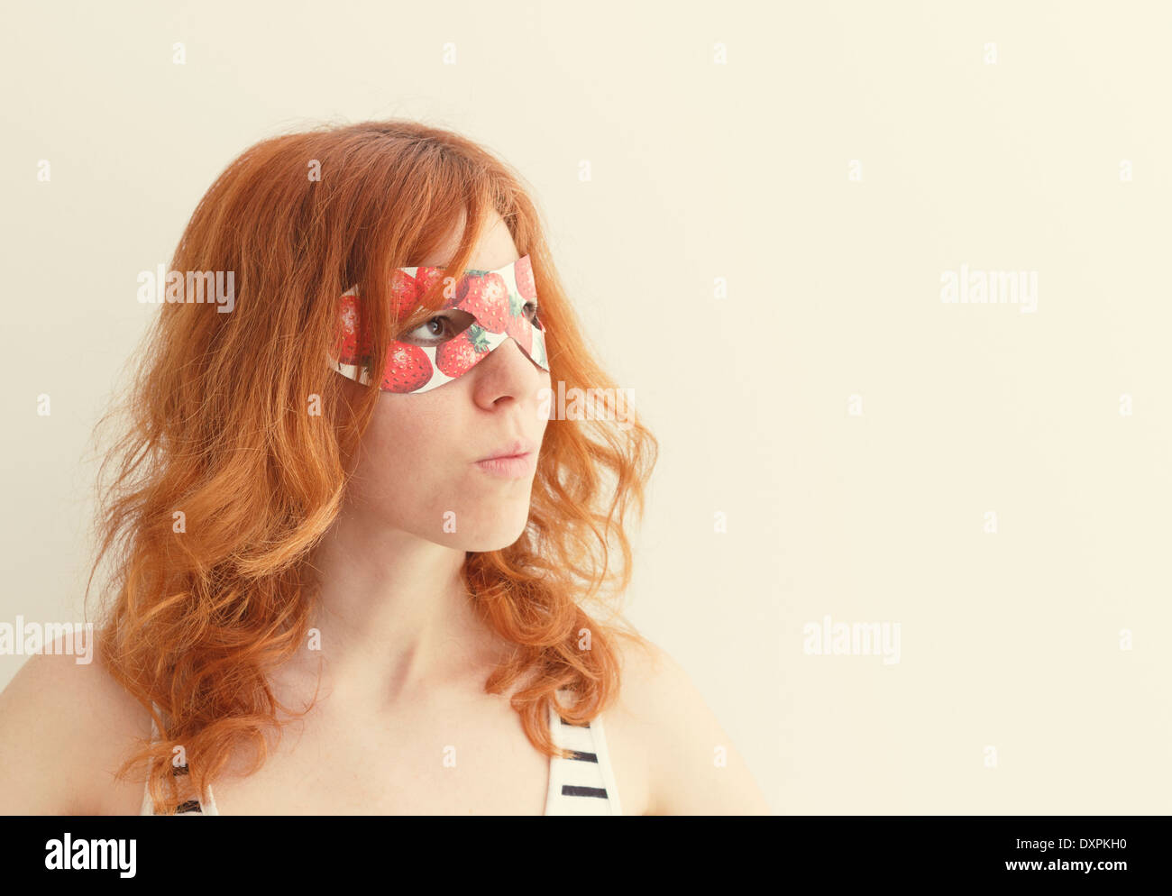 Superhero girl wearing mask with strawberries Stock Photo