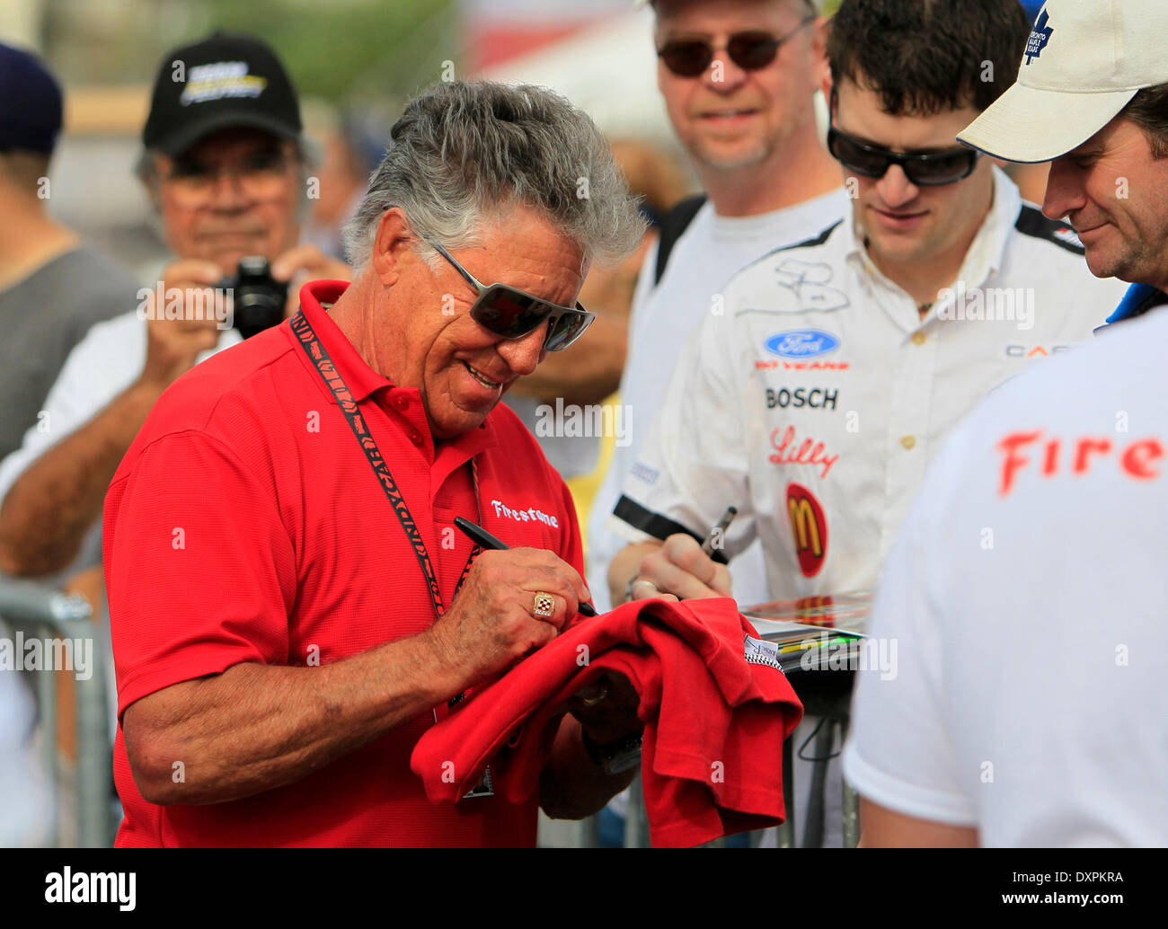St. Petersburg, Florida, USA. 28th Mar, 2014. DIRK SHADD | Times .Mario Andretti stops to sign autographs while heading out to pit lane for a practice session during the Firestone Grand Prix of St. Petersburg on Friday. © Dirk Shadd/Tampa Bay Times/ZUMAPRESS.com/Alamy Live News Stock Photo