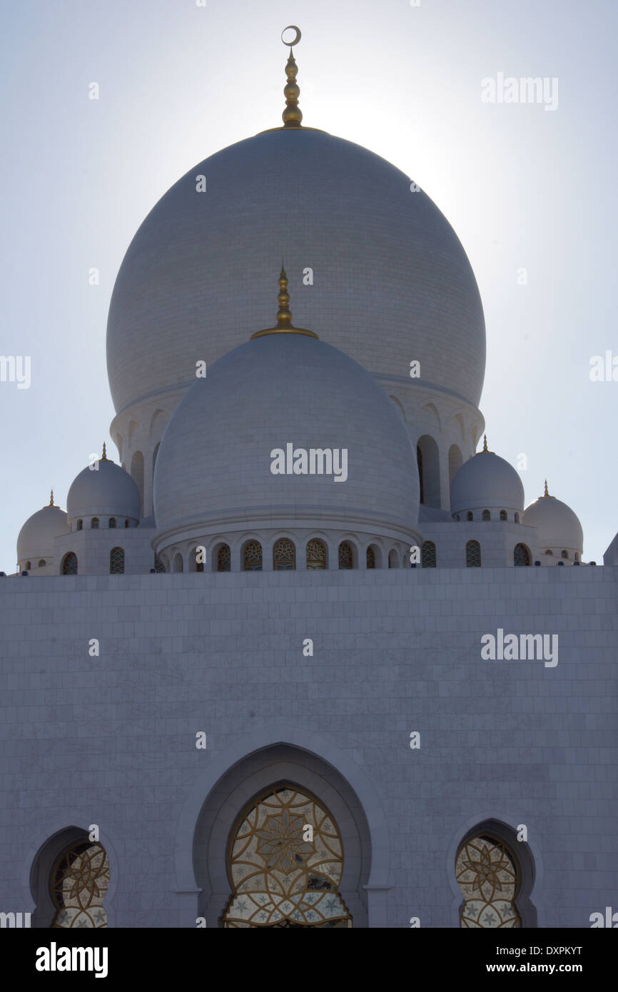 Domes at the Sheikh Zayed Grand Mosque at sunset Stock Photo