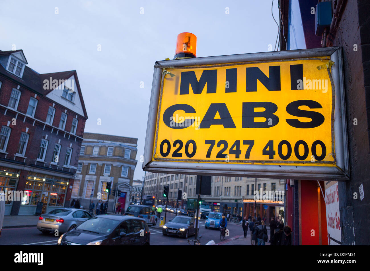 Mini cabs flashing orange light and sign, Spitalfields, London, England, UK Stock Photo