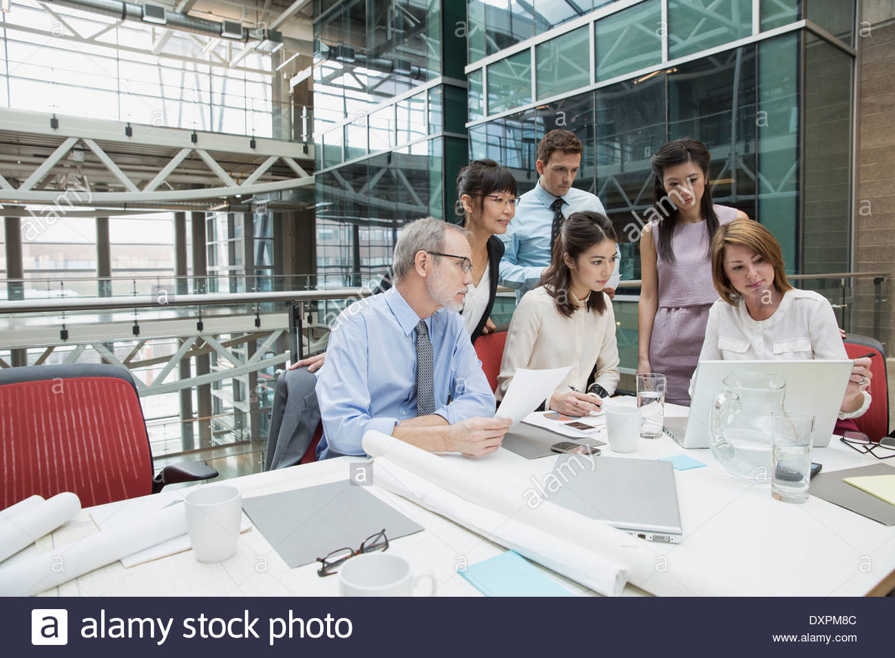 Business people using laptop in conference room meeting Stock Photo Alamy
