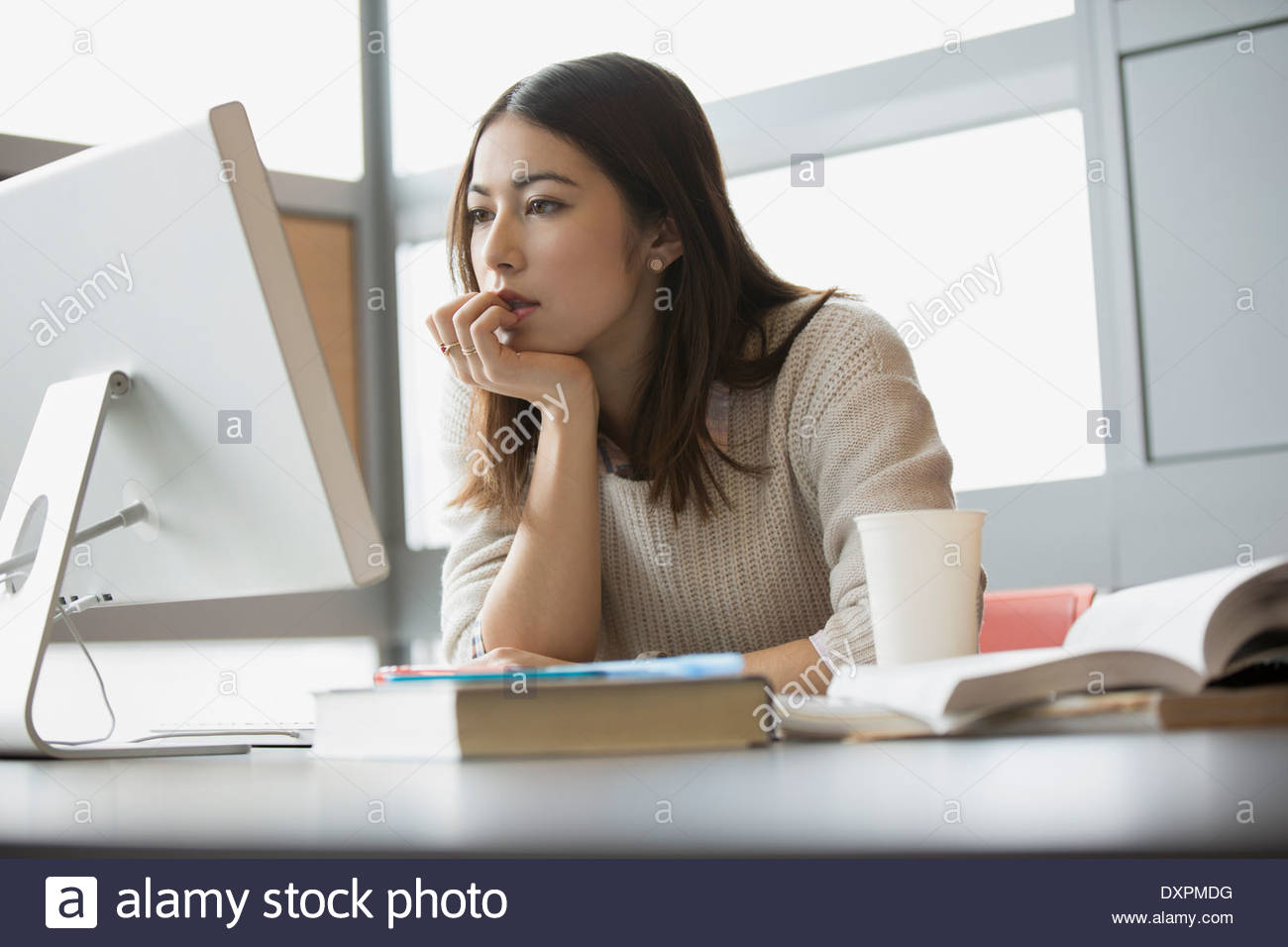 Focused college student studying at computer Stock Photo