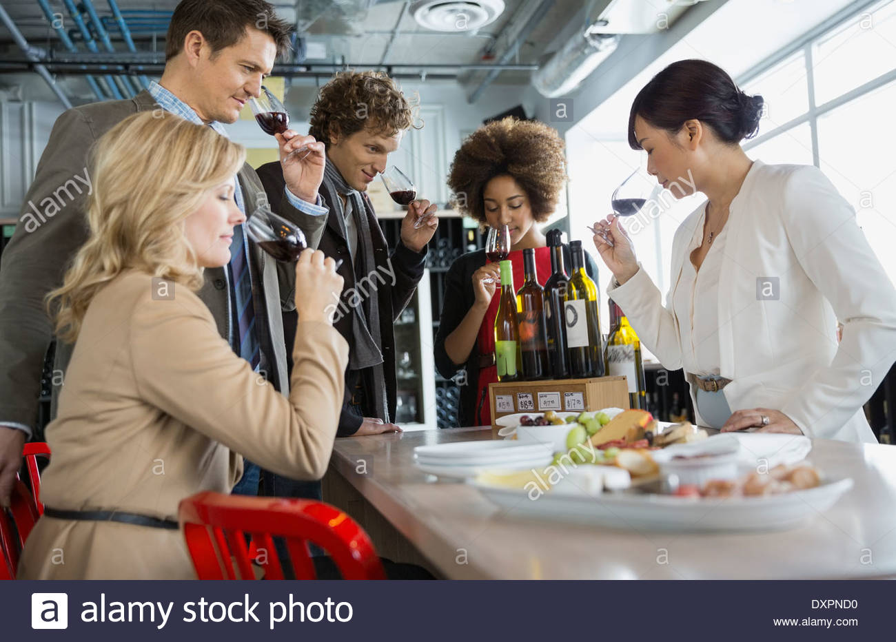 Sommelier and couples wine tasting in store Stock Photo