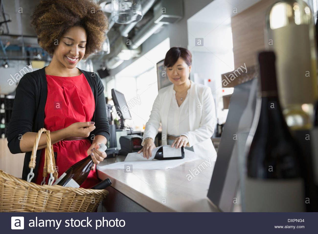 Woman purchasing wine in store Stock Photo - Alamy
