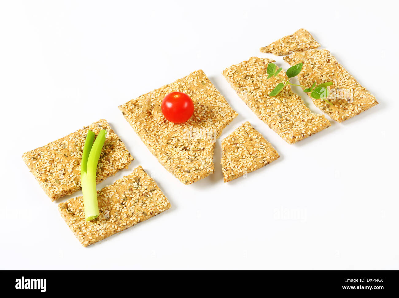 Whole wheat crackers with sesame seeds and chopped herbs Stock Photo