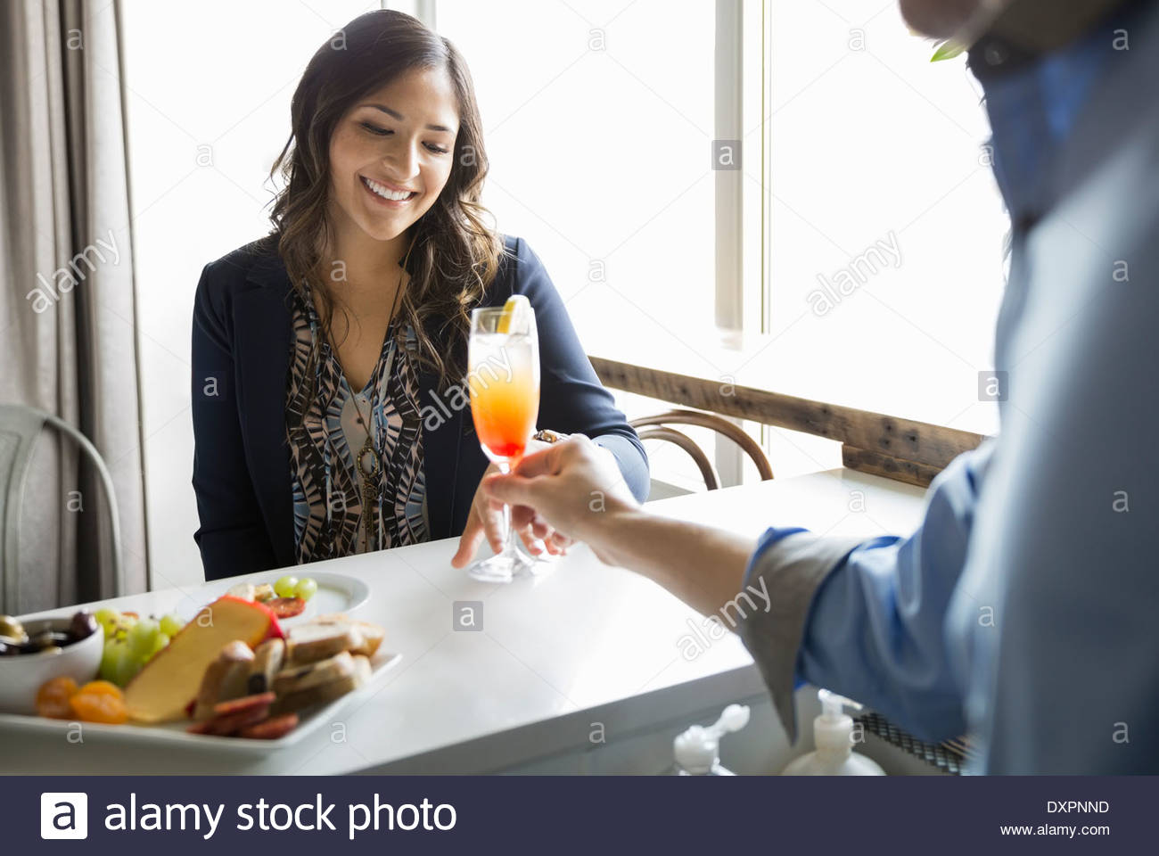 Bartender serving woman cocktail at bar Stock Photo