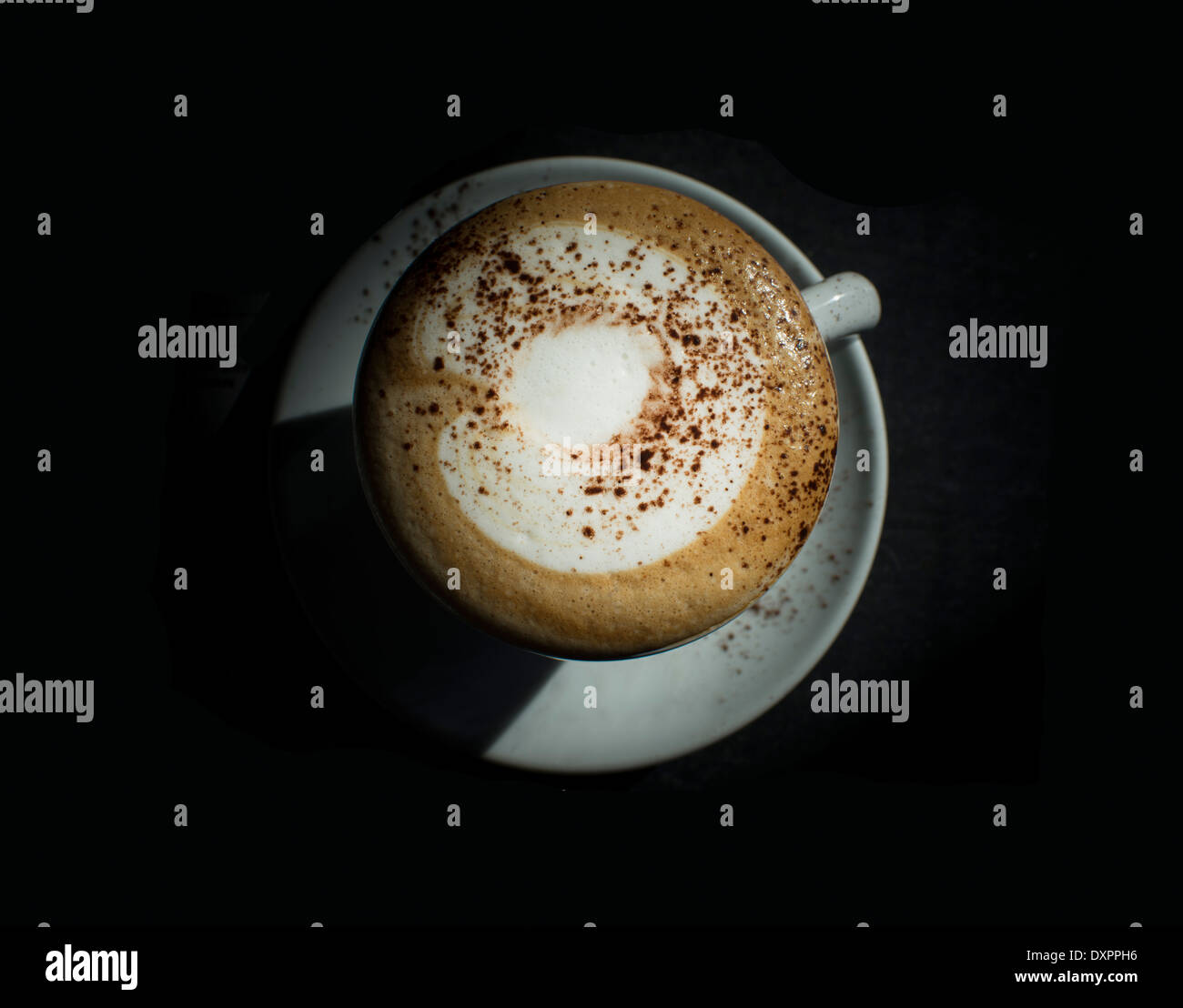 Capucchino in the dark isolated on black Stock Photo - Alamy