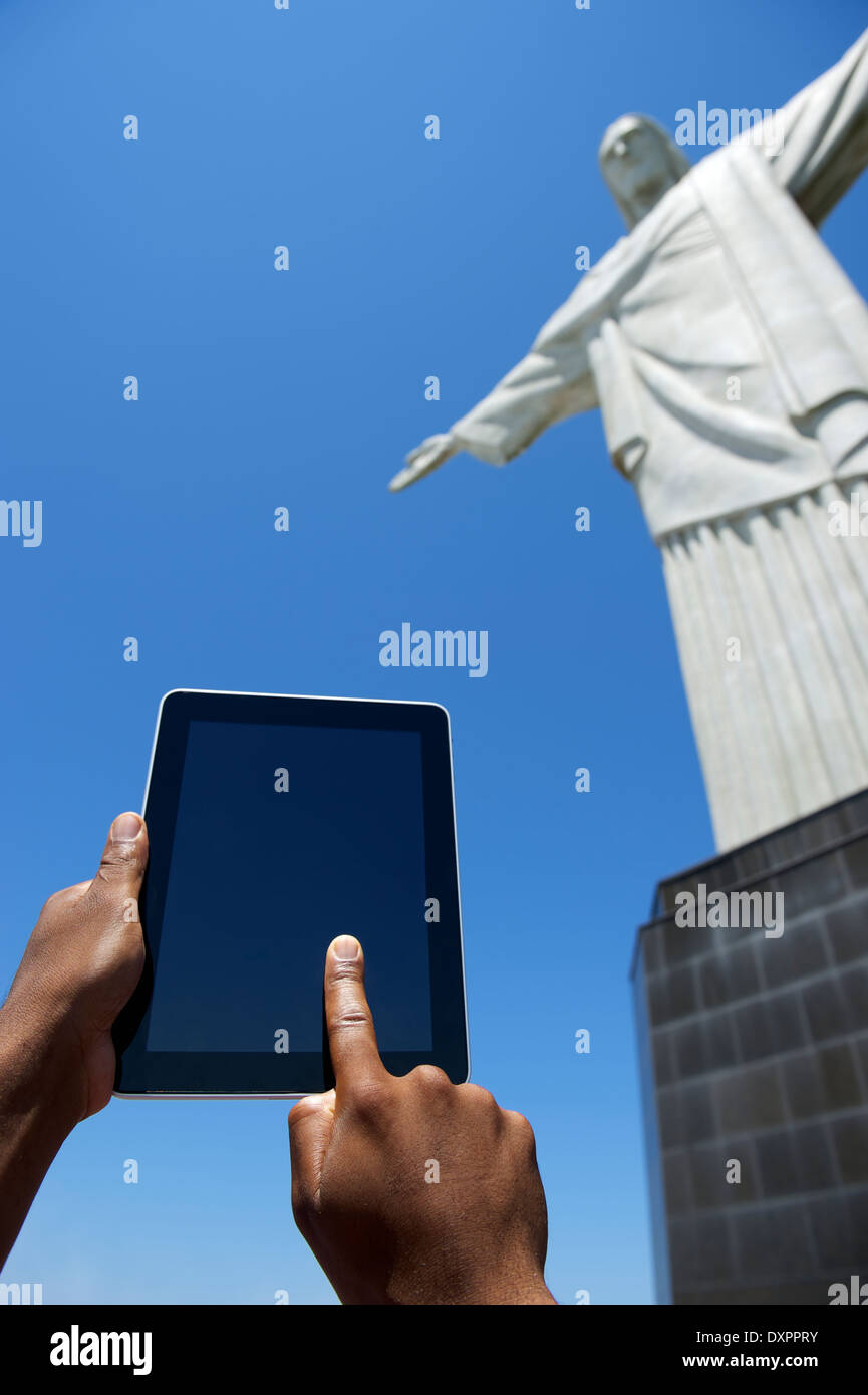 Traveling Brazilian tourist using tablet computer at Corcovado Christ the Redeemer Rio de Janeiro Brazil Stock Photo
