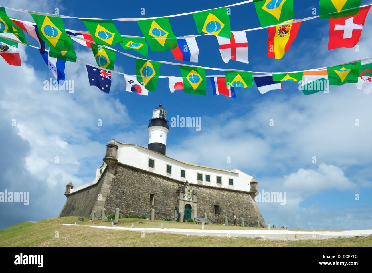 Portrait of the Farol da Barra Salvador Brazil lighthouse with celebratory international flag bunting Stock Photo