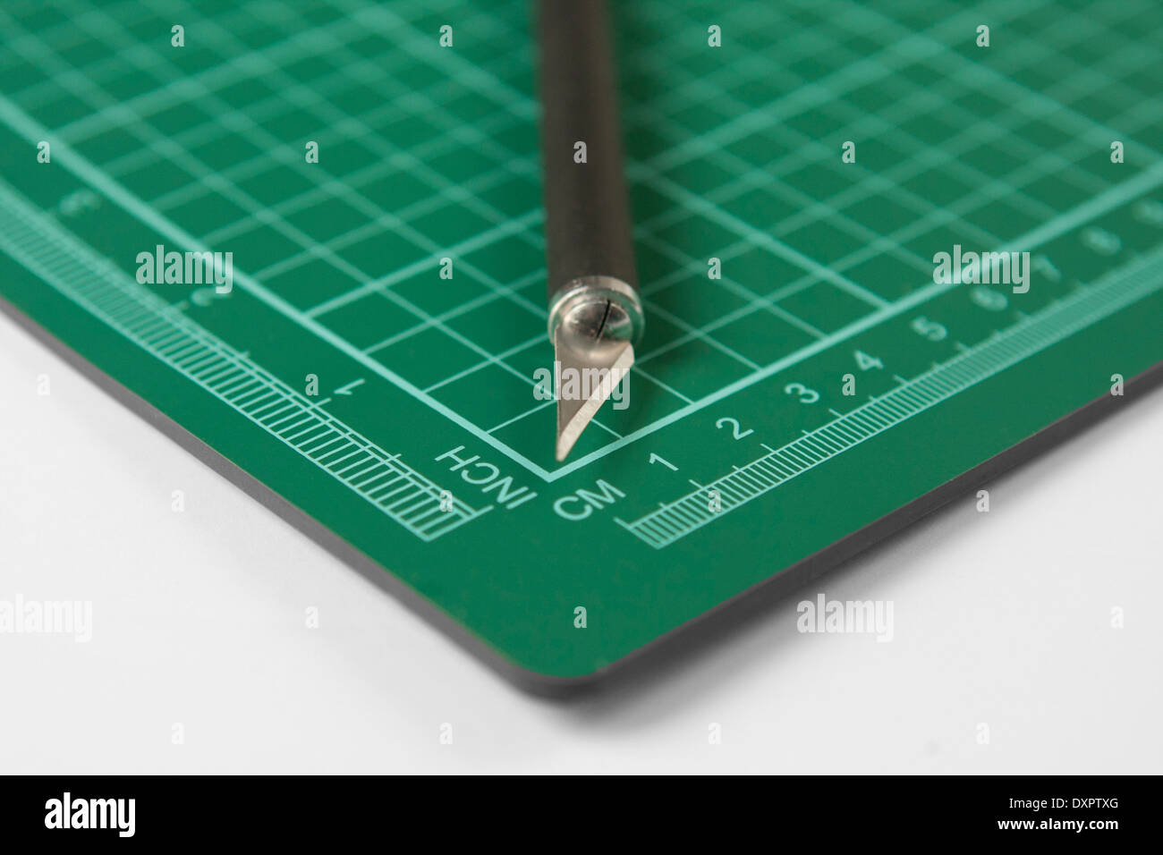 Sharp cutting blade on a green grid hobby mat, measured in inch and cm  Stock Photo - Alamy