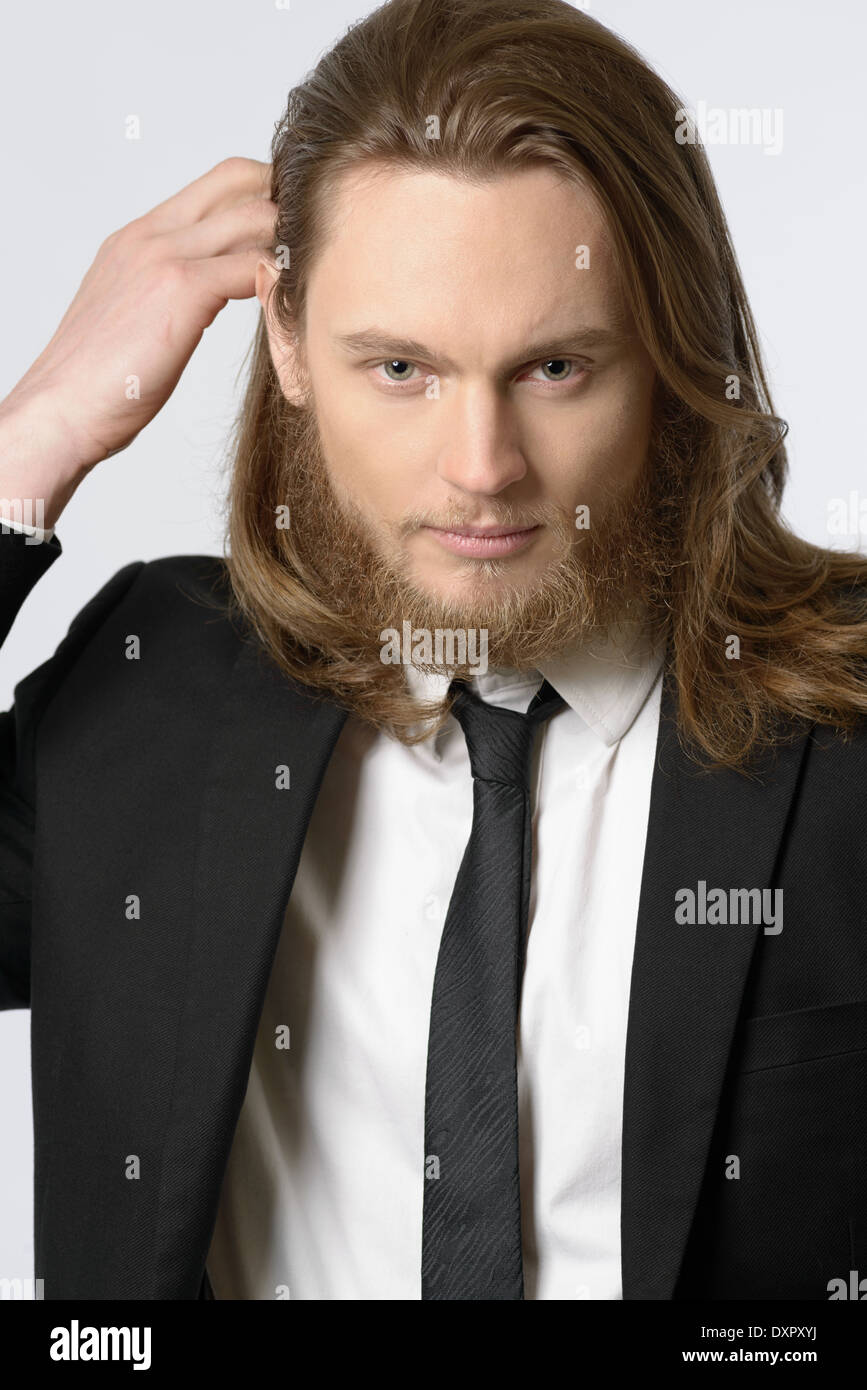 A long hair man, male model with beard wearing necktie and suit close-up portrait Stock Photo