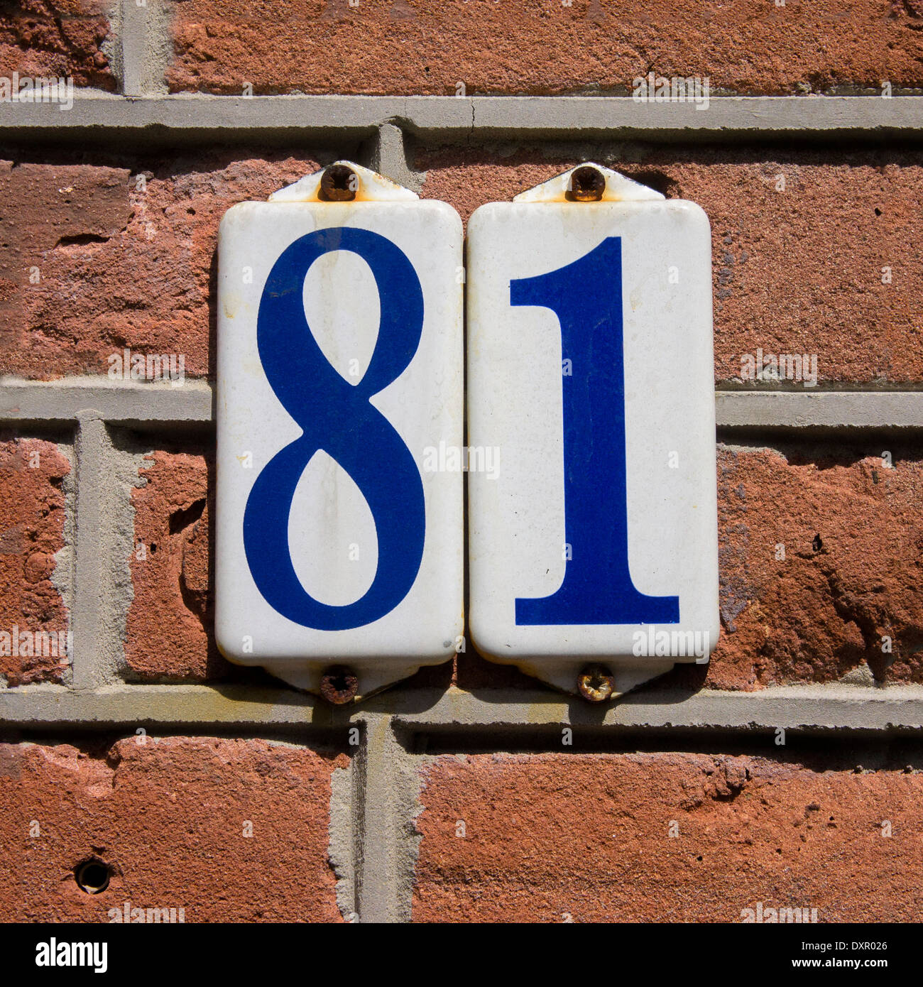 enameled house number eighty one. Blue lettering on a white background. Stock Photo