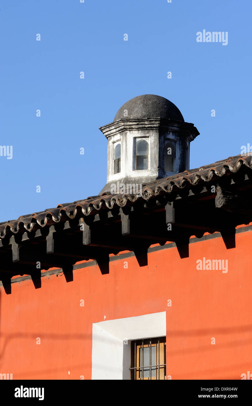 A cupola above a tiled trof and a red plastered wall, Antigua Guatemala, Republic of Guatemala. Stock Photo