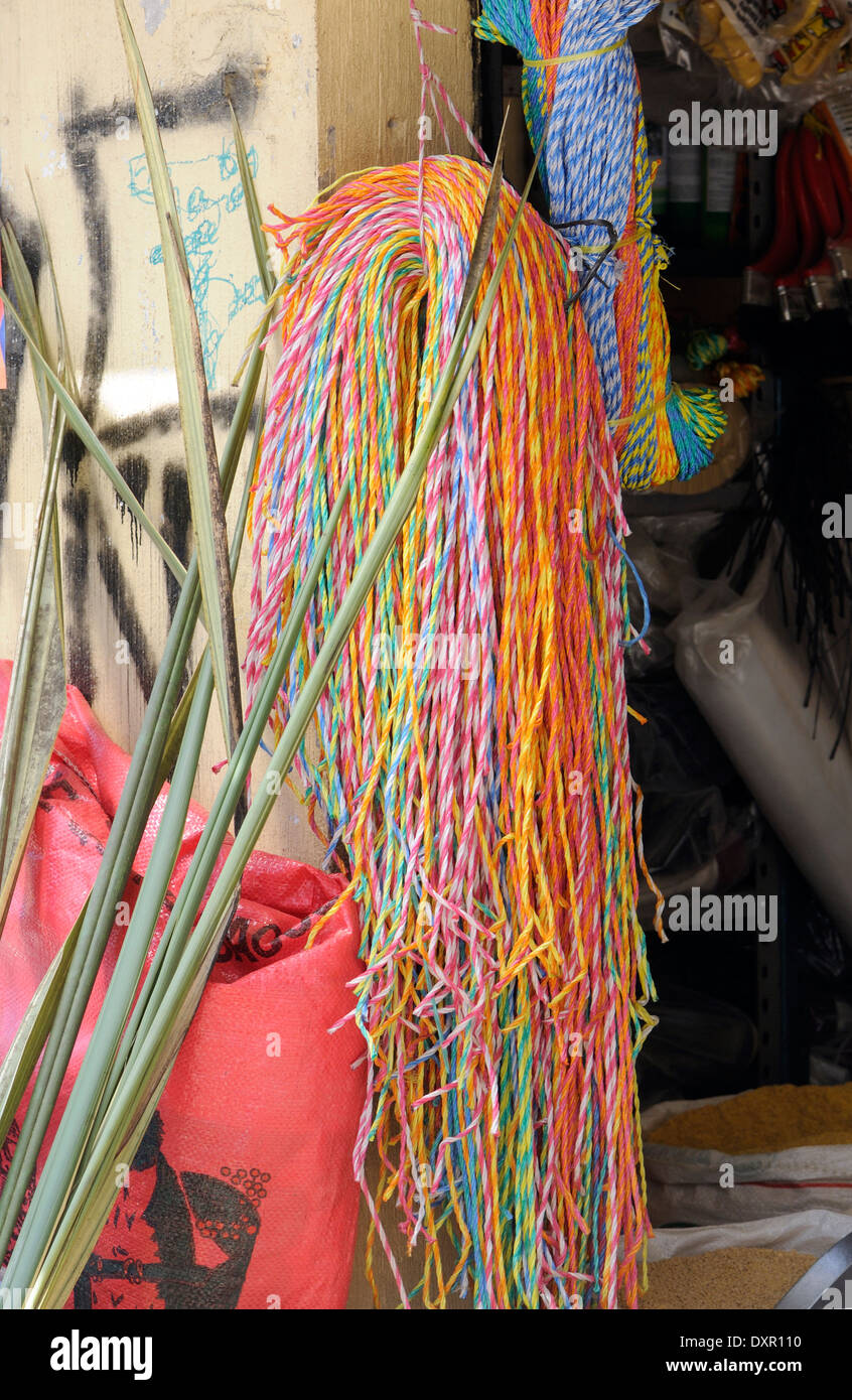 Brightly coloured plastic string for sale outside a shop in the  market  at Almolonga. San Pedro de Almolonga, Guatamala Stock Photo