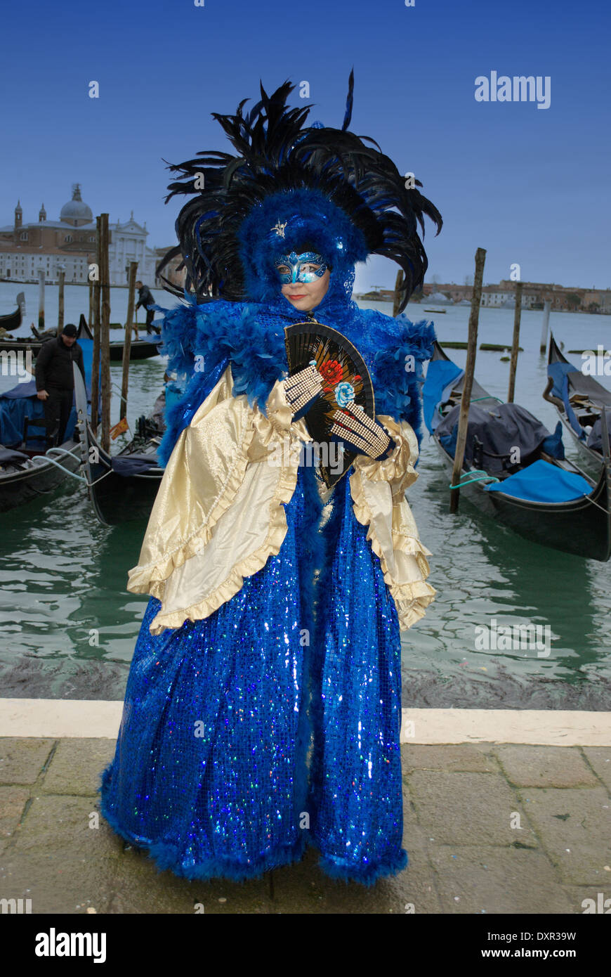 Luxurious blue and gold costume and gondola boats in Venice