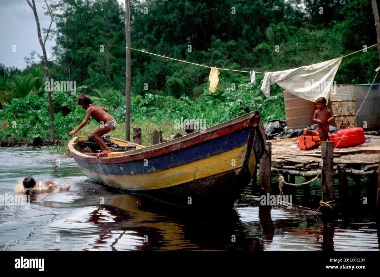A boat in the Orinoco River. The Warao are an indigenous people inhabiting northeastern Venezuela and western Guyana. Alternate Stock Photo