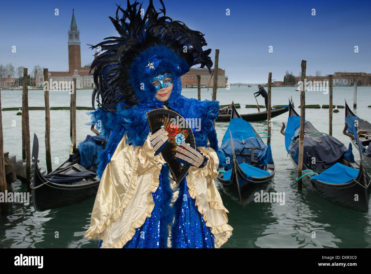 Luxurious blue and gold costume and gondola boats in Venice