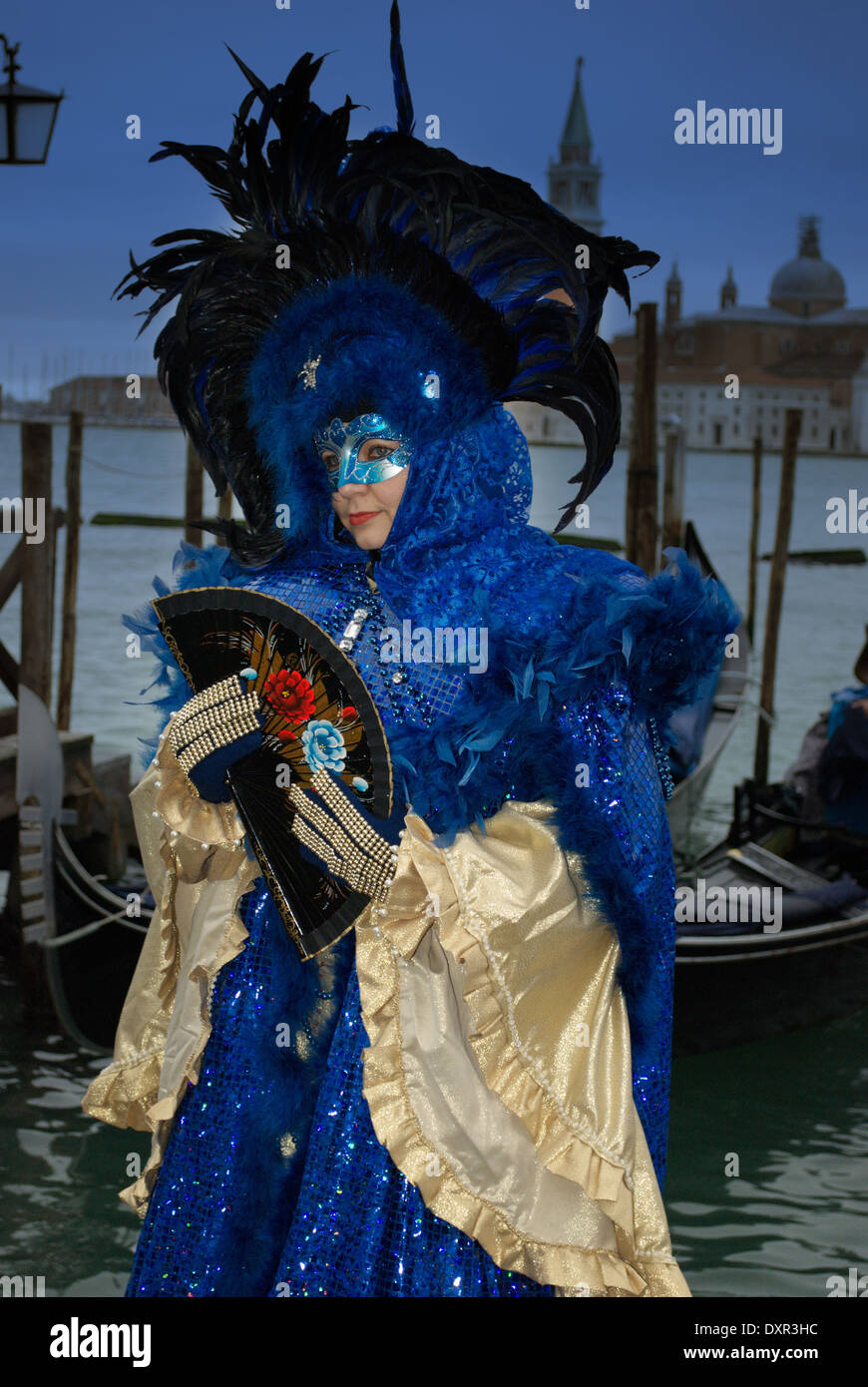 Luxurious blue and gold costume and gondola boats in Venice