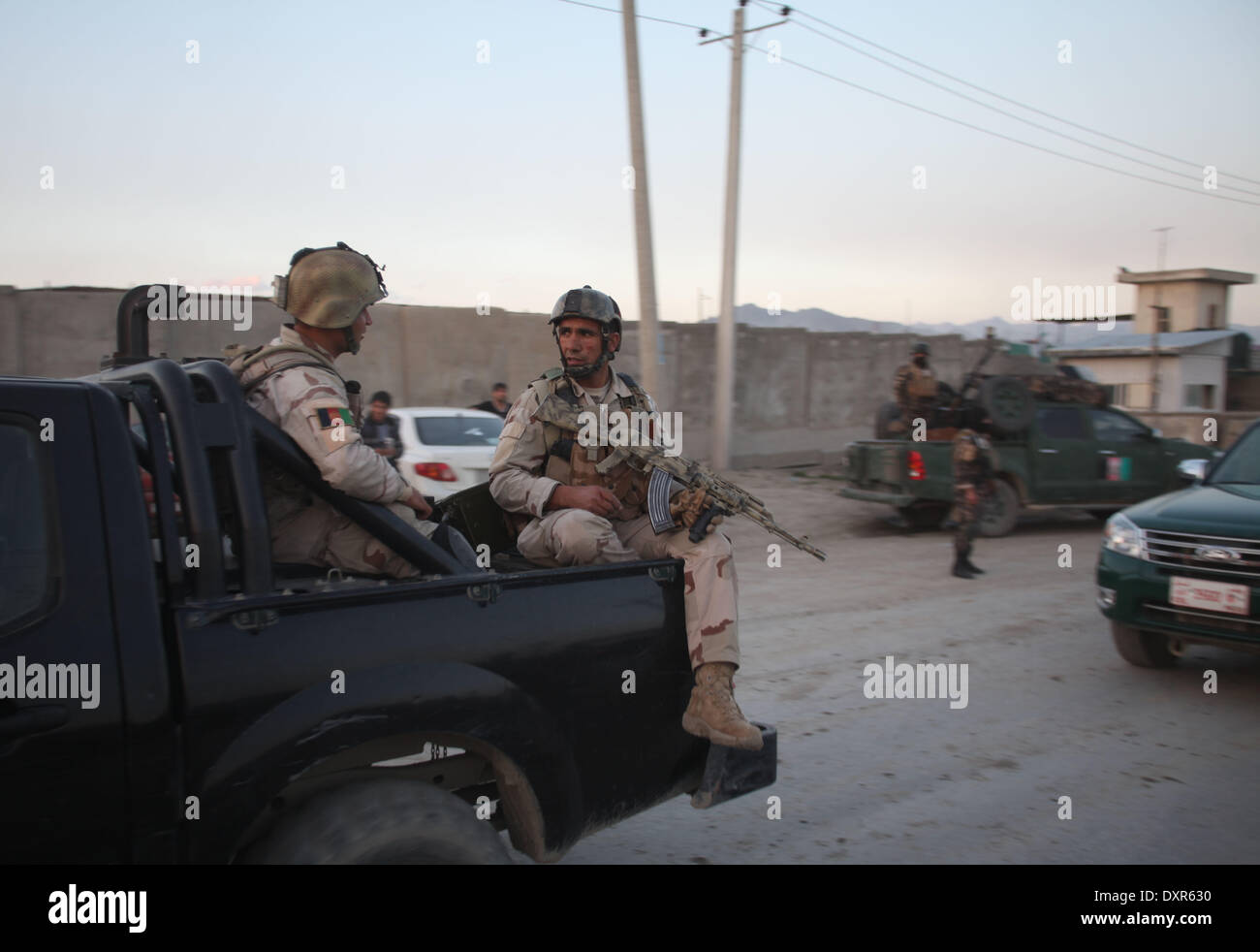 Kabul, Afghanistan. 29th Mar, 2014. Afghan soldiers leave the site of the attack close to the election office in Kabul, Afghanistan on March 29, 2014. A five-hour gun fight close to the Afghanistan's main election office in Kabul ended Saturday evening after Taliban gunmen were killed in the counter-attack, an official said. Credit:  Ahmad Massoud/Xinhua/Alamy Live News Stock Photo