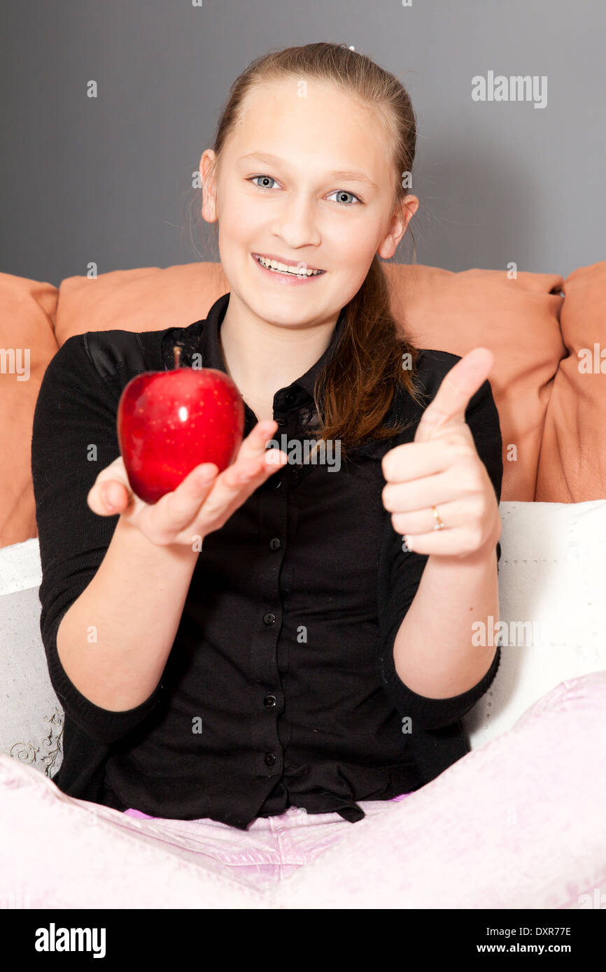 casual girl eating a red apple Stock Photo