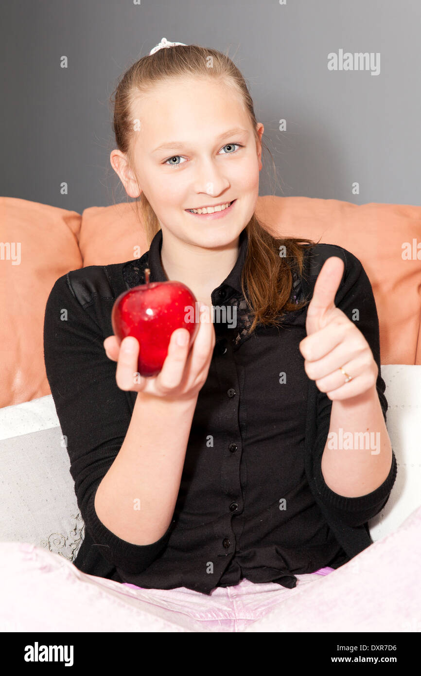 casual girl eating a red apple Stock Photo