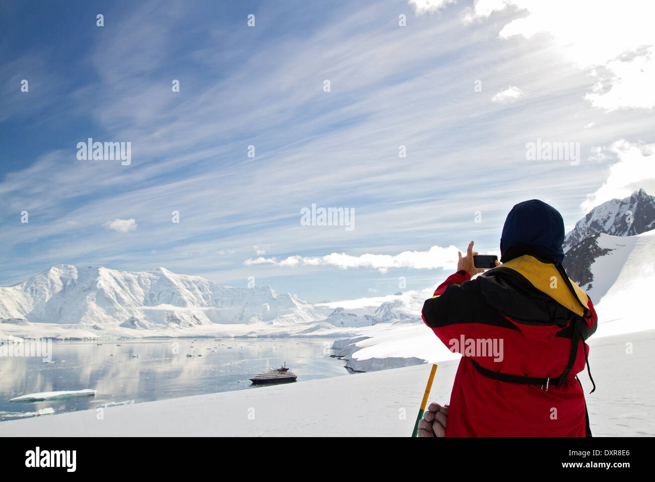 Antarctica tourists on cruise ship, boat enjoy Antarctic landscape. Captures scenery with iPhone. Stock Photo