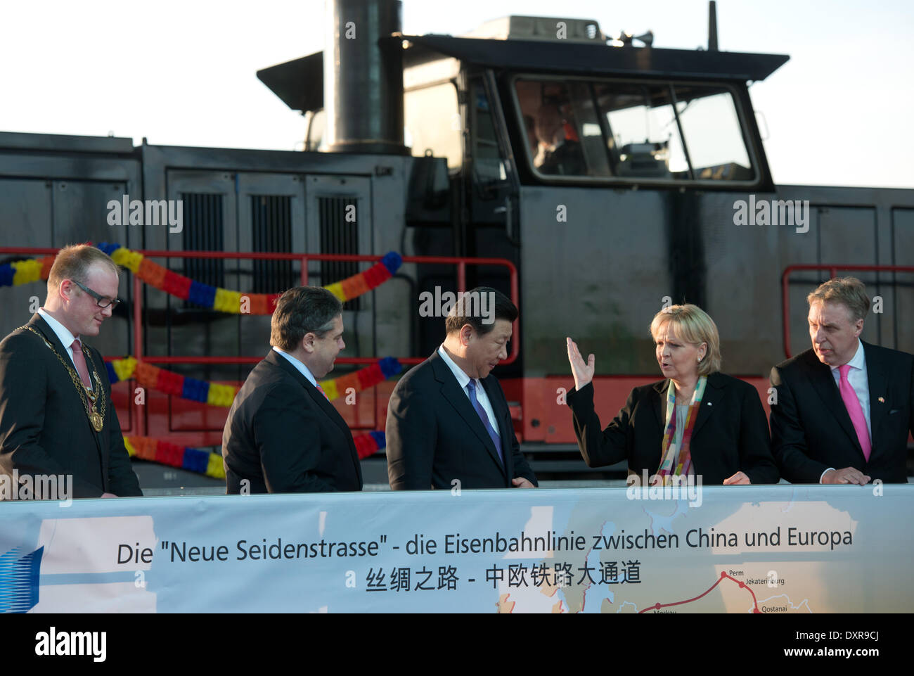 Duisburg, Germany. 29th Mar, 2014. China's president Xi Jinping (C) stands between Duisburg's mayor Soeren Link, German Minister of Economics and Energy Sigmar Gabriel (SPD), governor of North Rhine-Westphalia Hannelore Kraft and head of Duisburg's harbour Logport Erich Staake (L-R) in front of the train 'Yuxinou' in Duisburg, Germany, 29 March 2014. Xi proceeds his tour of Germany in North Rhine-Westphalia. Photo: Bernd Thissen/dpa/Alamy Live News Stock Photo
