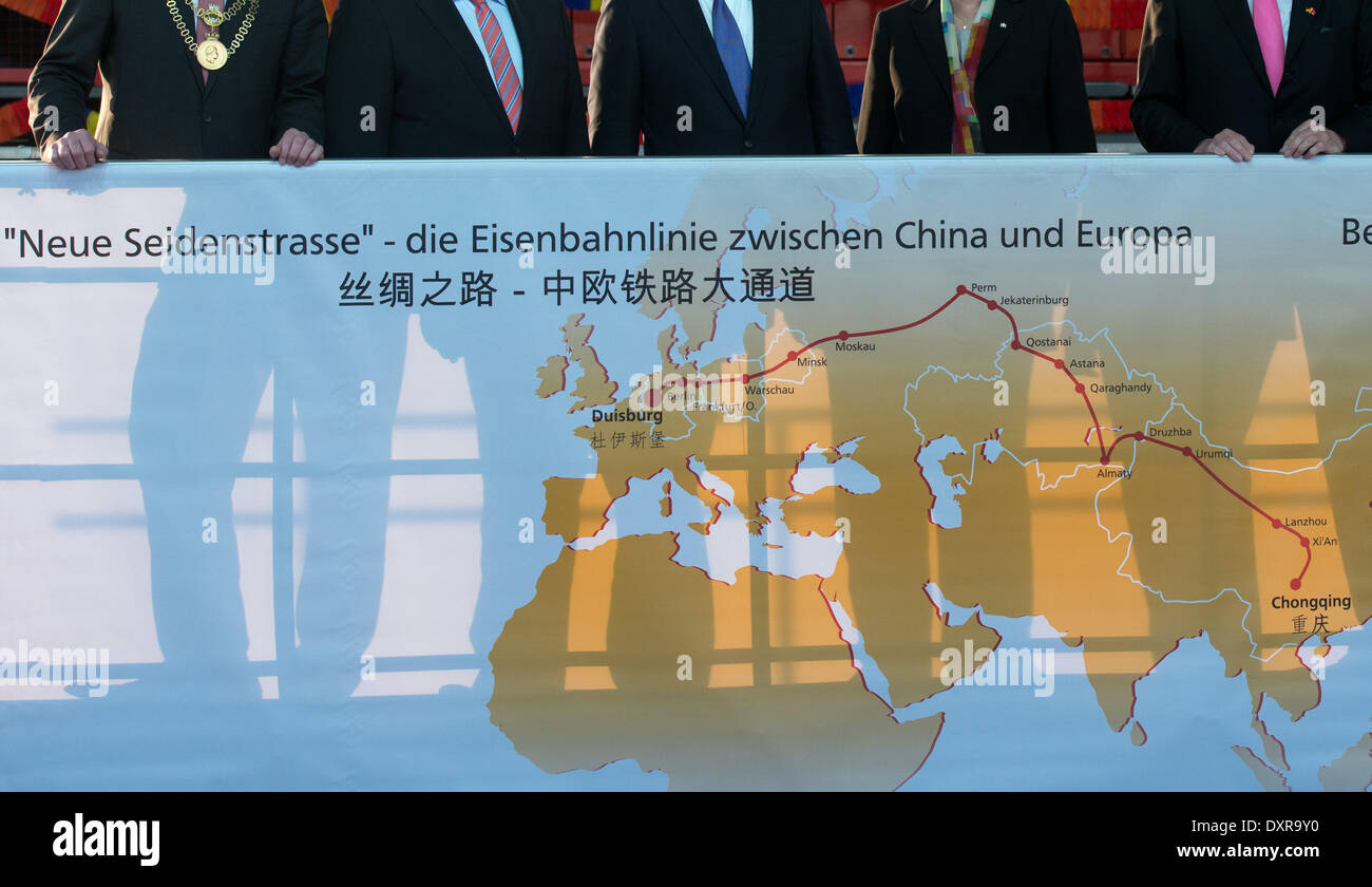 Duisburg, Germany. 29th Mar, 2014. The shadows of China's president Xi Jinping (C), Duisburg's mayor Soeren Link, German Minister of Economics and Energy Sigmar Gabriel (SPD), governor of North Rhine-Westphalia Hannelore Kraft and head of Duisburg's harbour Logport Erich Staake (L-R) can be seen in Duisburg, Germany, 29 March 2014. Xi proceeds his tour of Germany in North Rhine-Westphalia. Photo: Bernd Thissen/dpa/Alamy Live News Stock Photo