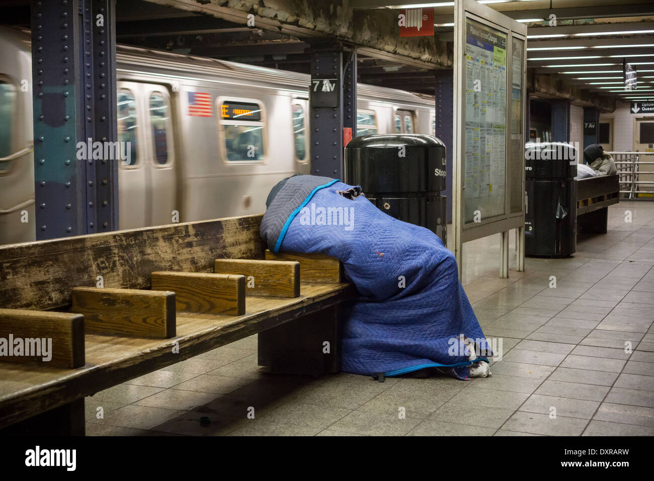 Undomiciled individual escapes the cold on a subway platform in New York on Friday, March 28, 2014. (© Richard B. Levine) Stock Photo