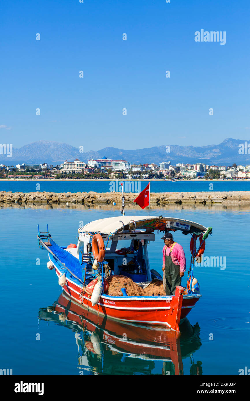 Fishing boat in the old town harbour looking towards beaches and hotel zone to west of the town, Side, Antalya Province, Turkey Stock Photo