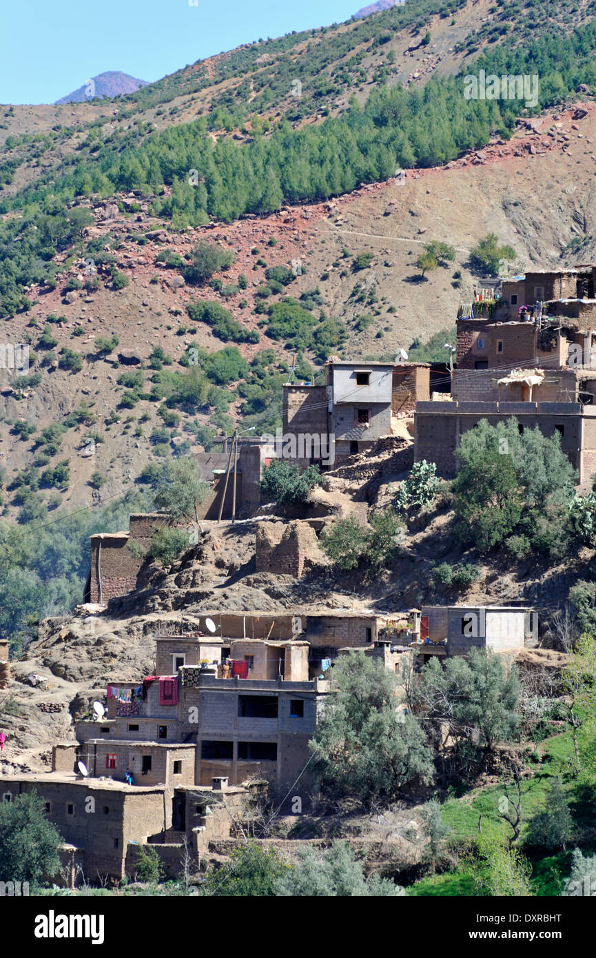 On steep hillside Berber village near Tadmamt in Atlas mountains on road to Oukaimeden from Marrakech, Morocco Stock Photo