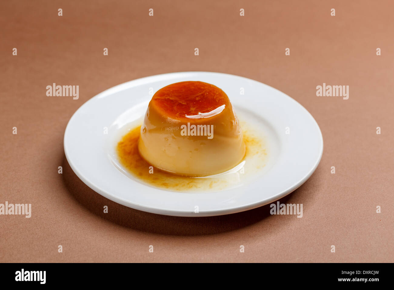 Creme caramel on white plate Stock Photo