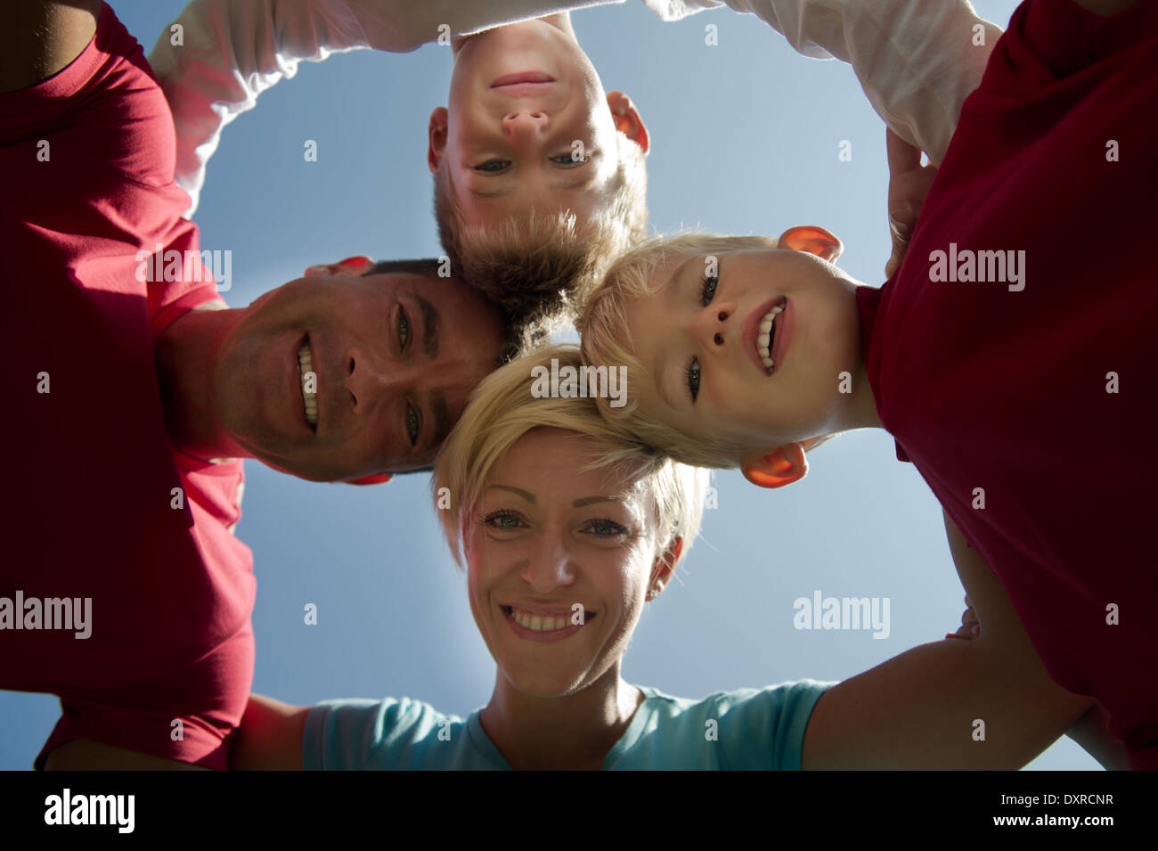 Family interlocking arms and touching heads together Stock Photo Alamy
