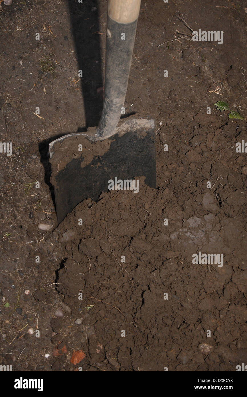 image of spade in heavy clay soil Stock Photo